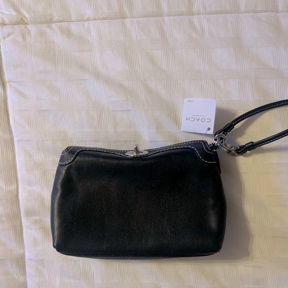 NWT Coach black leather wristlet with white stitching.